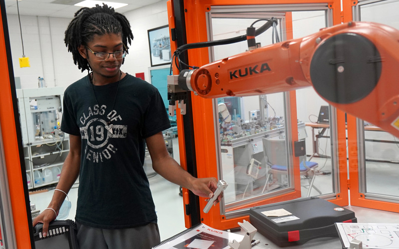 Mech student with robot