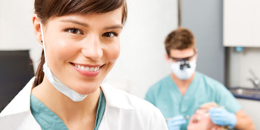 smiling dental assistant in dentist's office