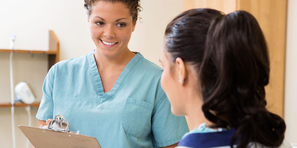 female Medical assistant talking to patient