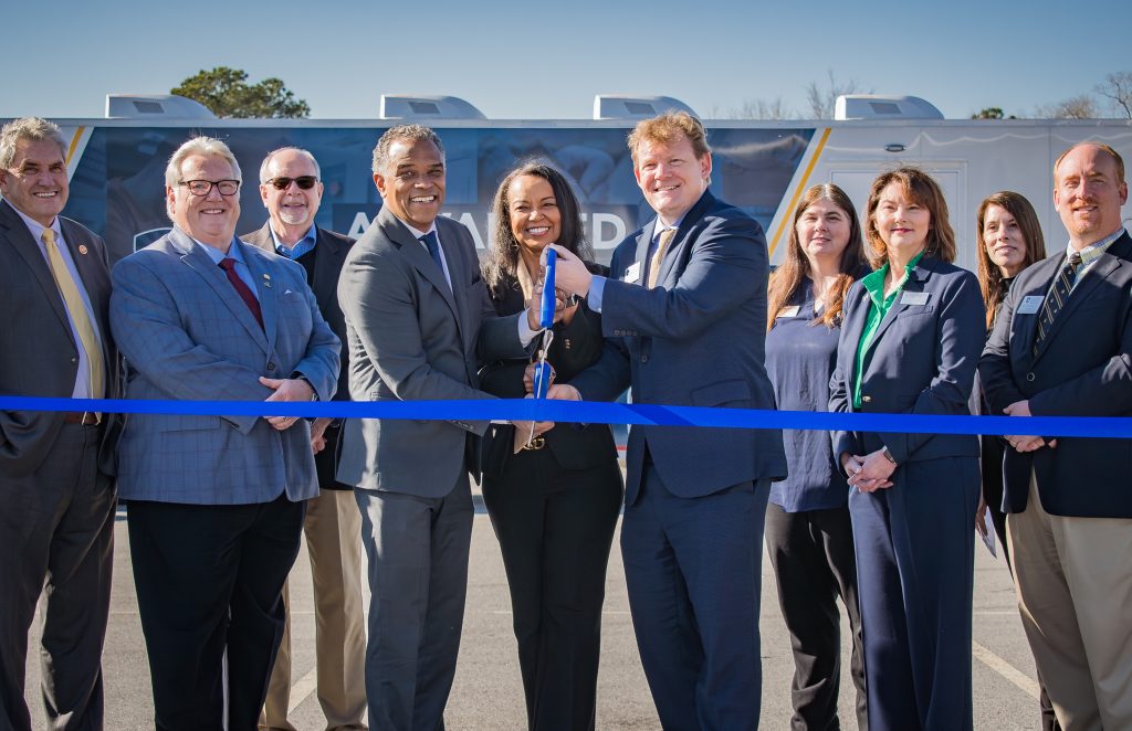 OCtech President Dr. Walt Tobin, center left, joins PTC President Dr. Hope Rivers and ATC President Dr. Forest Mahan cut the ribbon for the new mobile Advanced Manufacturing Labs.