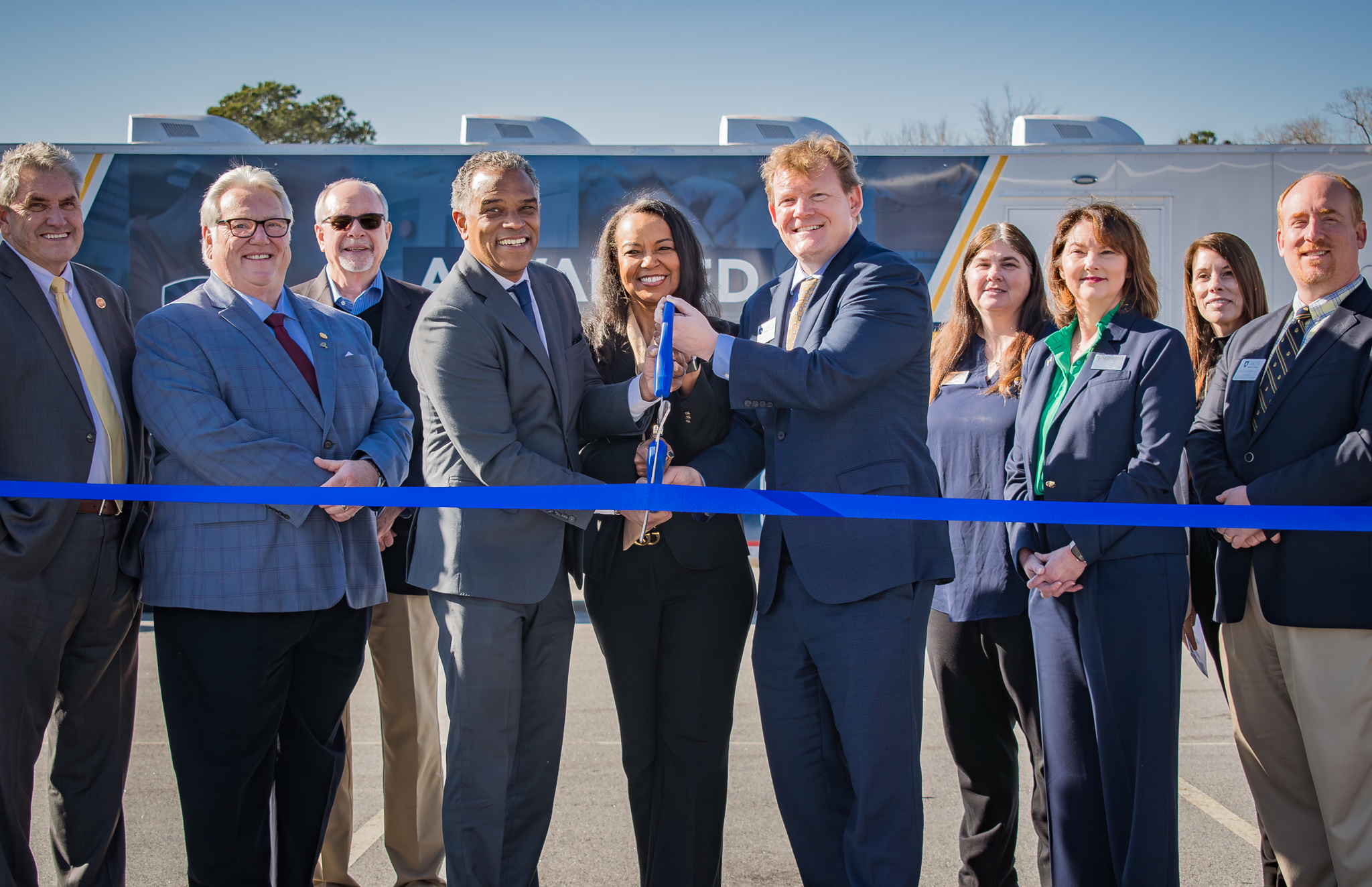 OCtech President Dr. Walt Tobin, center left, joins PTC President Dr. Hope Rivers and ATC President Dr. Forest Mahan cut the ribbon for the new mobile Advanced Manufacturing Labs.