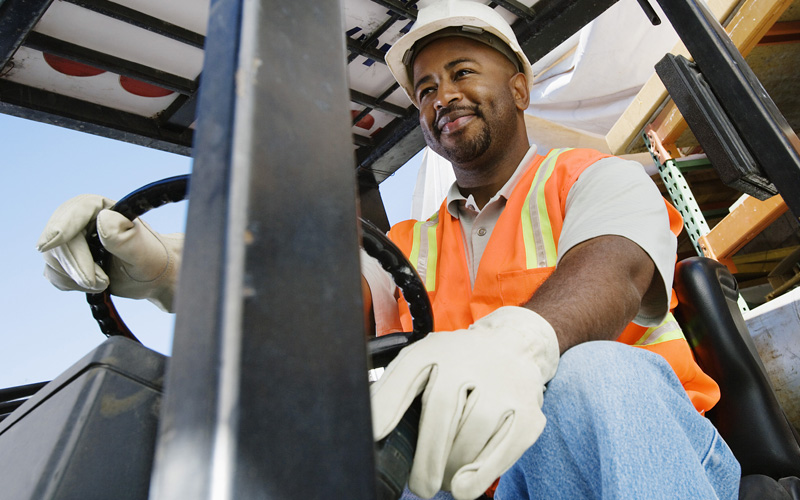 smiling forklift driver on forklift