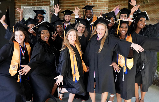 group of graduates in cap and gown