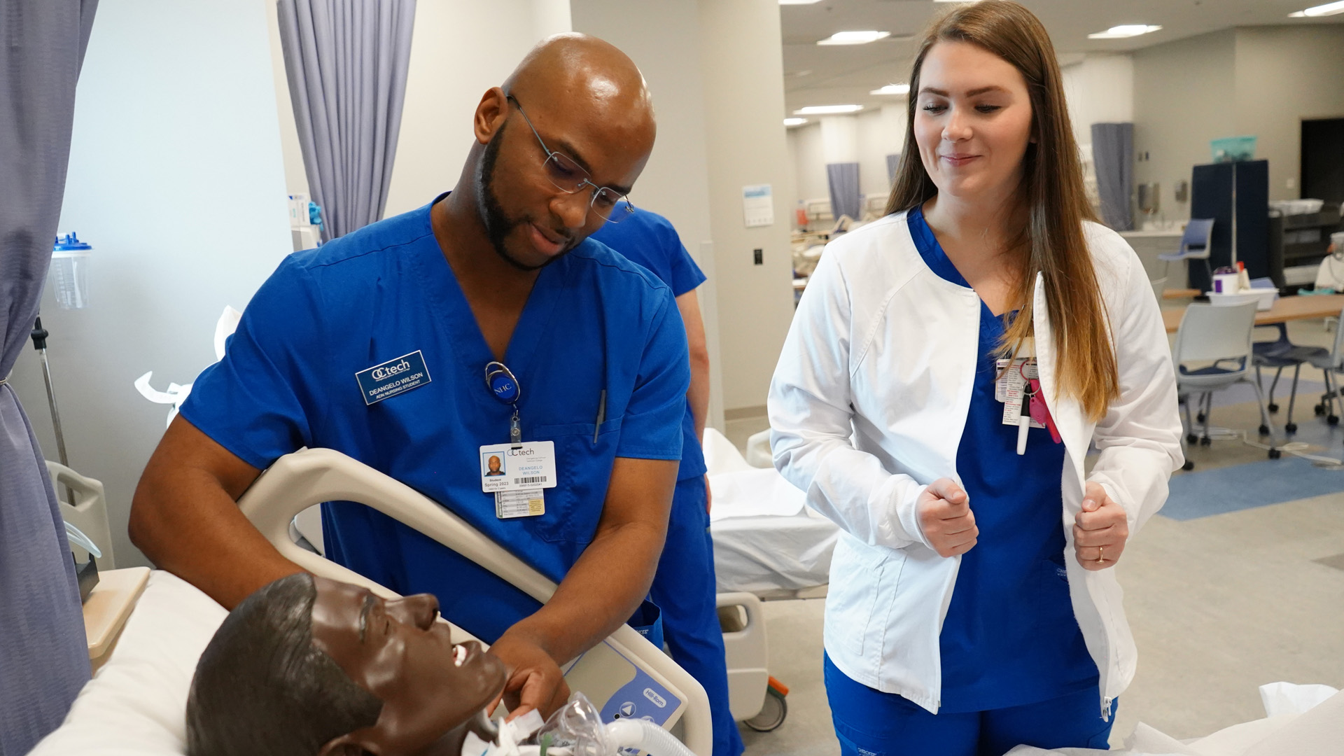 nursing student in lab with patient dummy