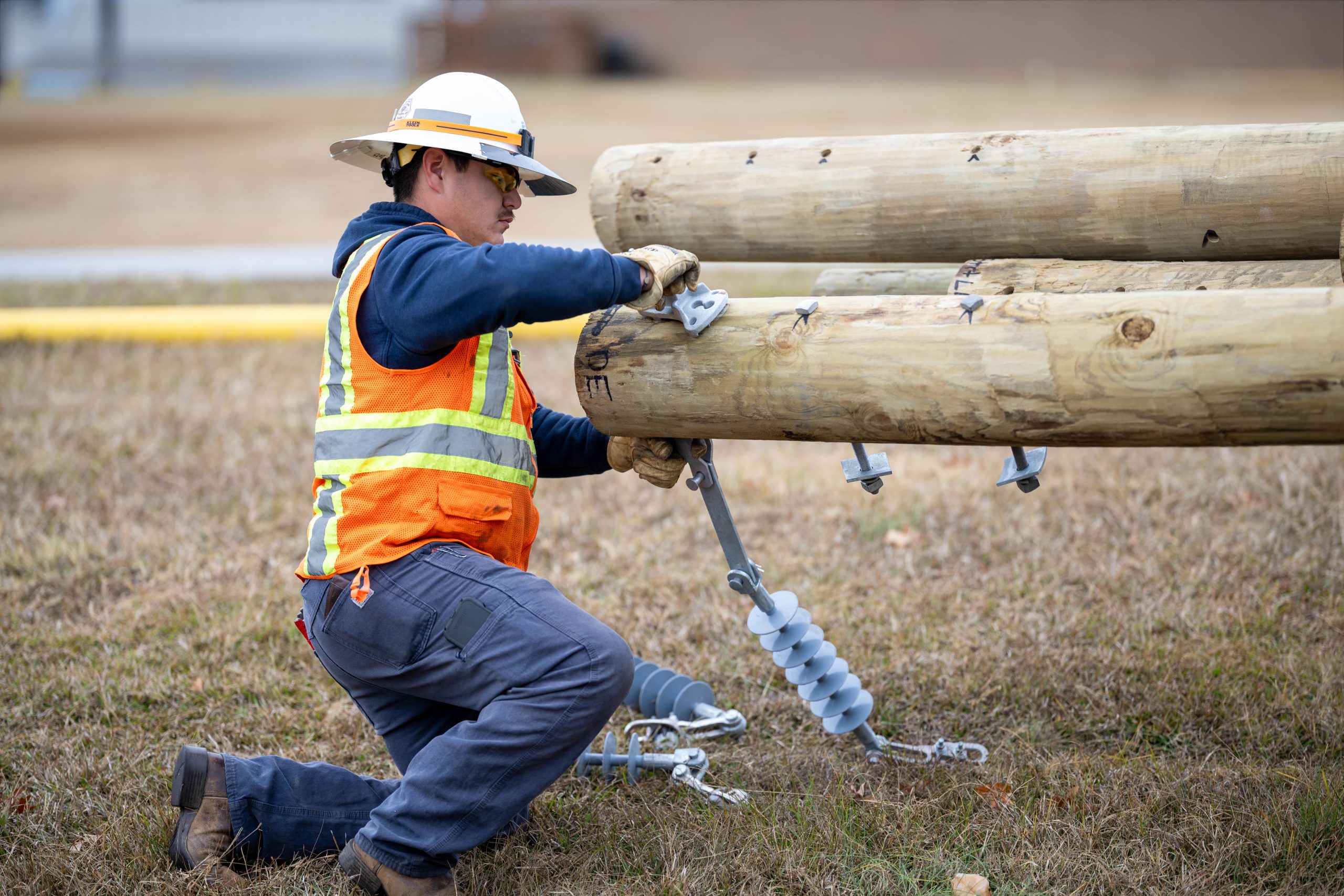 Dominion Energy workers install utility poles at OCtech.