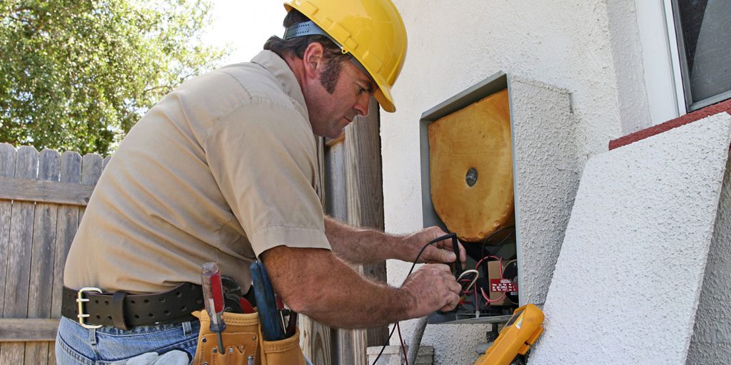 HVAC man servicing AC  unit